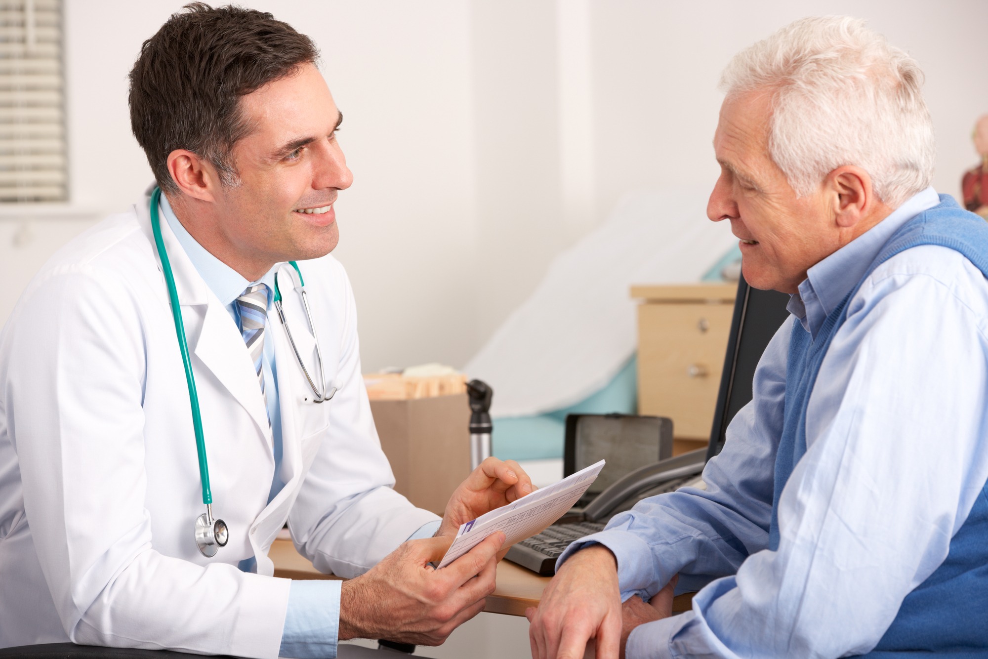 Doctor talking to elderly man.